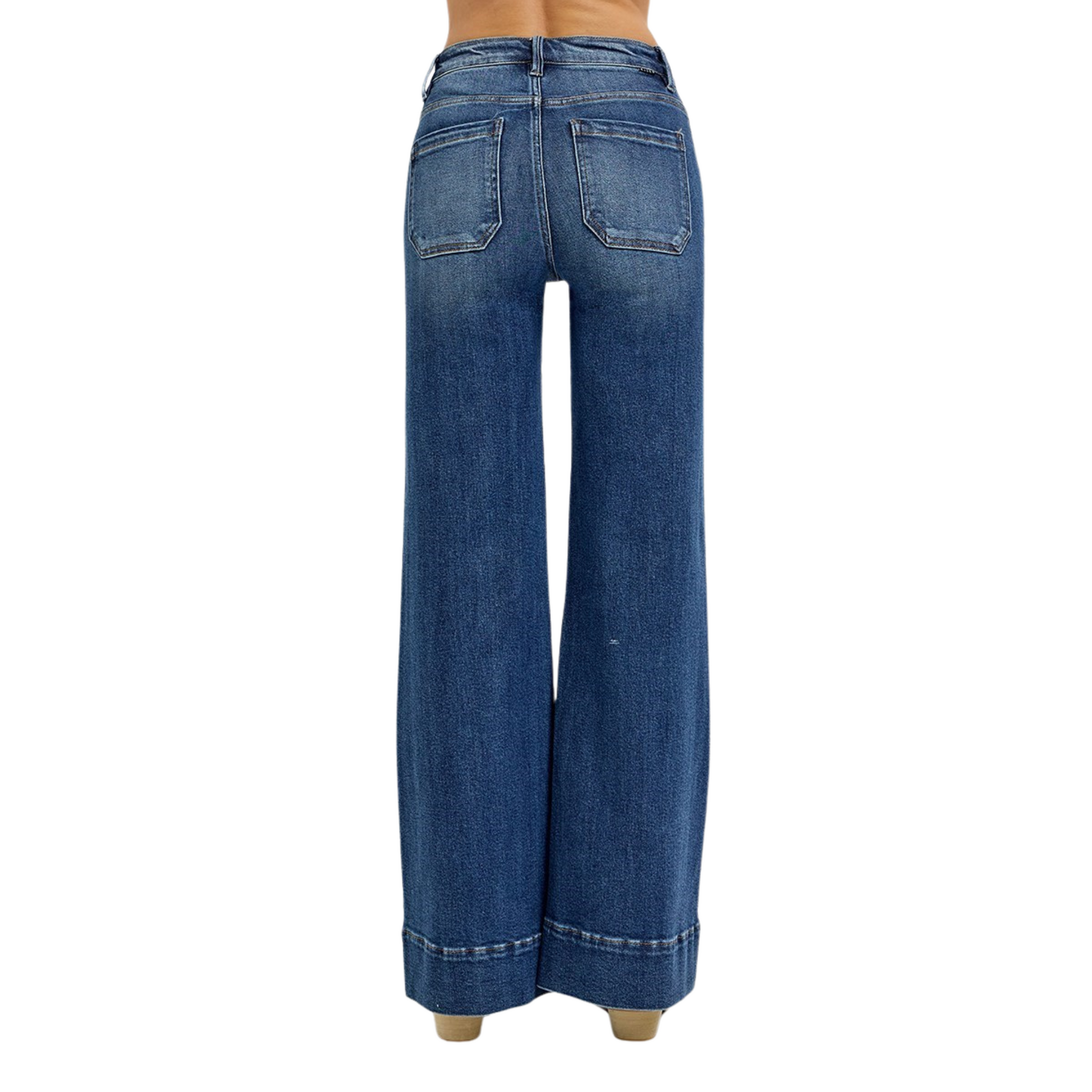 Crafted by Risen, these High Rise Flare Jeans in a deep dark wash offer a sophisticated silhouette with their wide-leg cut that elongates the legs. The high-rise design ensures a flattering fit around the waist, while the patch pocket detailing adds a contemporary, functional touch. Ideal for those seeking a blend of classic denim style and modern tailoring, these jeans provide both comfort and a polished look for versatile wear.