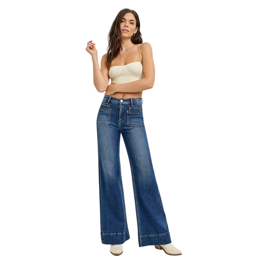 Crafted by Risen, these High Rise Flare Jeans in a deep dark wash offer a sophisticated silhouette with their wide-leg cut that elongates the legs. The high-rise design ensures a flattering fit around the waist, while the patch pocket detailing adds a contemporary, functional touch. Ideal for those seeking a blend of classic denim style and modern tailoring, these jeans provide both comfort and a polished look for versatile wear.