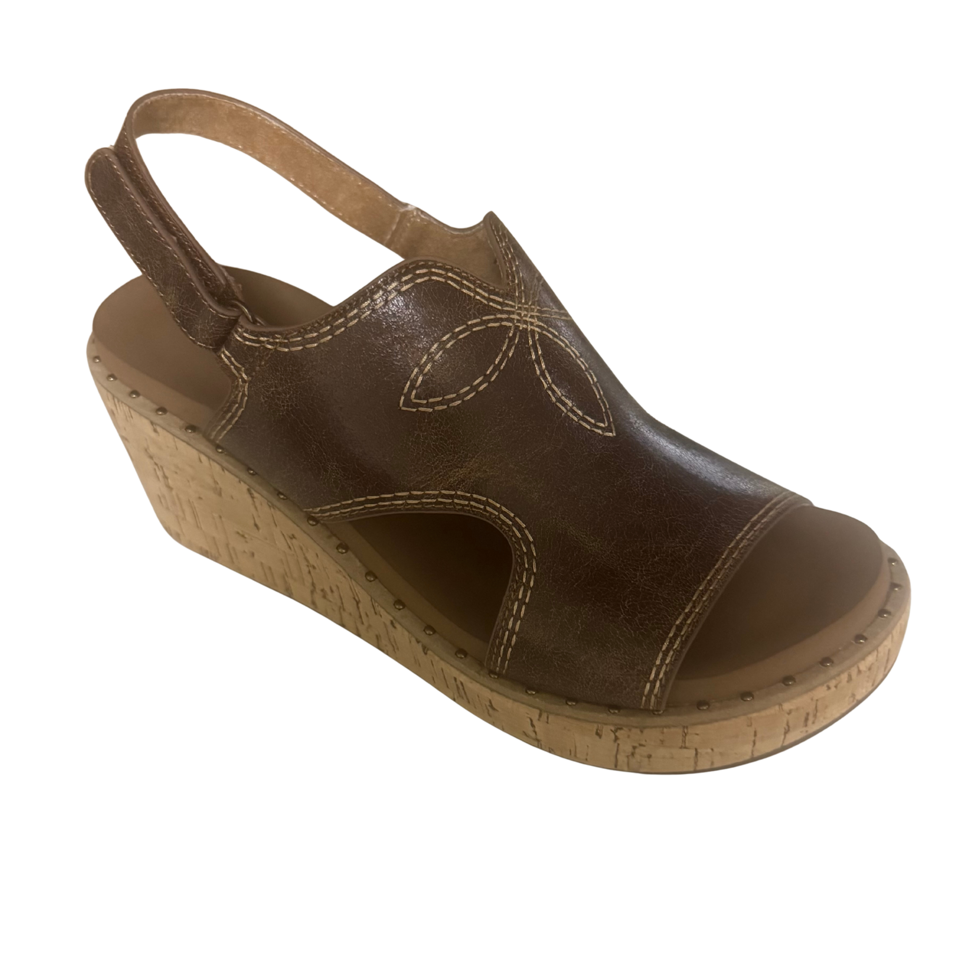 The Darlin brown wedge sandal from Corkys combines comfort with effortless style. Featuring a supportive wedge heel and quality construction, this versatile sandal transitions seamlessly from casual outings to weekend adventures. The rich brown tone pairs with any wardrobe, while the thoughtful design keeps your feet comfortable all day long. A timeless choice for those who value both function and fashion.