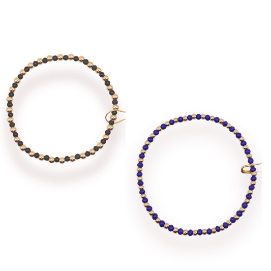 The Demi Bracelet by Beaded Blondes features delicate gold beads strung together for an elegant, versatile look. Available in cobalt blue or black, this piece effortlessly transitions from casual to dressed-up occasions. The timeless gold-and-bead design pairs beautifully with any outfit, making it a must-have addition to your jewelry collection.