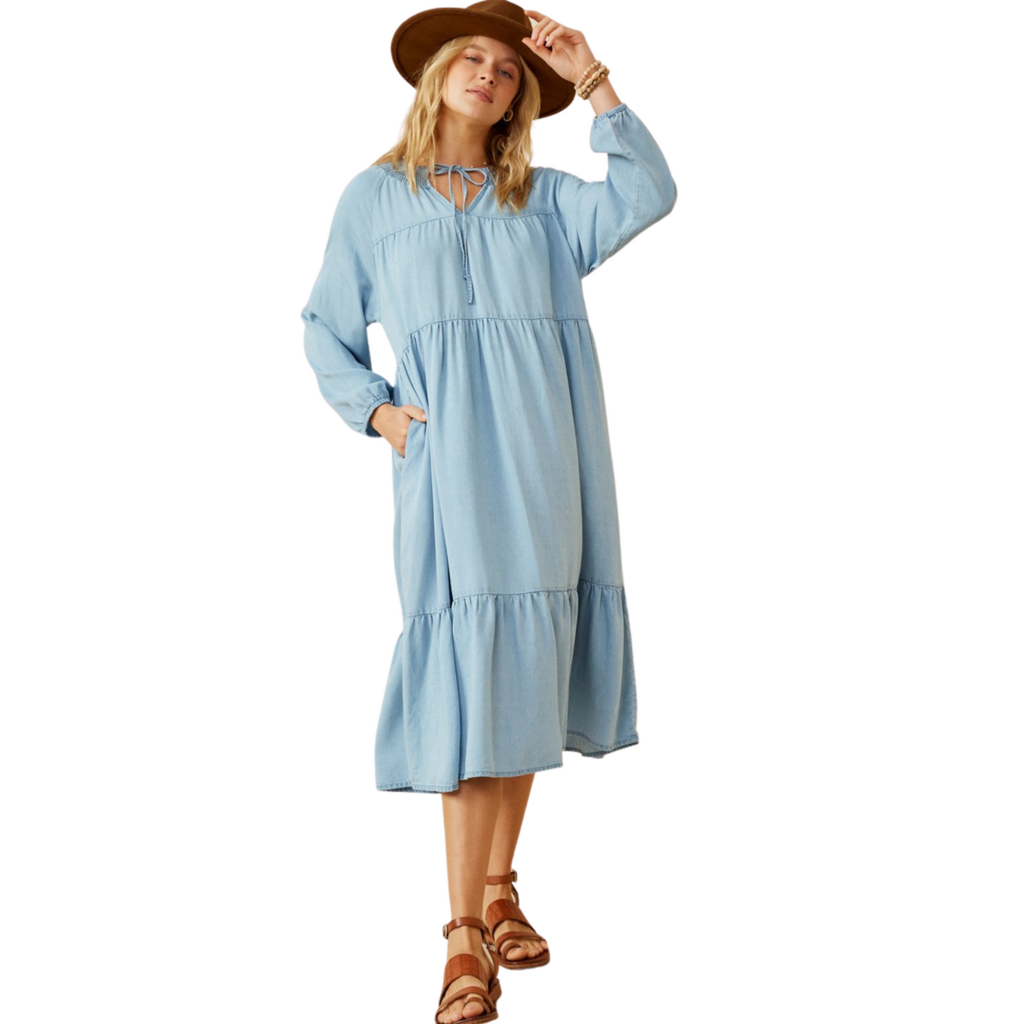 This Long Sleeve Tencel Dress offers contemporary style with a timeless denim fabrication. The womens smock detail ties at the neck and provides a sophisticated silhouette, while side pockets complete the design. Crafted from 100% Tencel, this dark denim dress is the perfect balance of modern and classic.