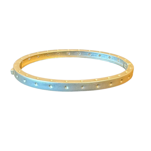 This timeless Cuff Bangle is gold-plated and features dot accents for a subtle and dainty design. Its simple, classic style ensures it can be worn for any occasion.