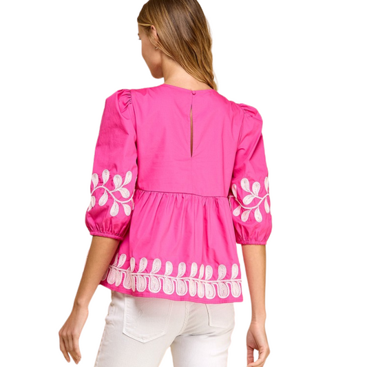 Expertly crafted with a beautiful fuchsia color, this peplum top boasts short puff sleeves and a contrasting embroidered design for a chic look. Complete with a back keyhole and button closures, this top is a statement piece for any occasion.