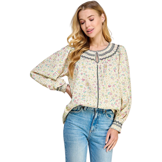 This classic cream-colored top features a popular tie front closure for a secure fit. With an elegant floral print, this top is perfect for any special occasion. Made of lightweight material, it provides a comfortable feel.