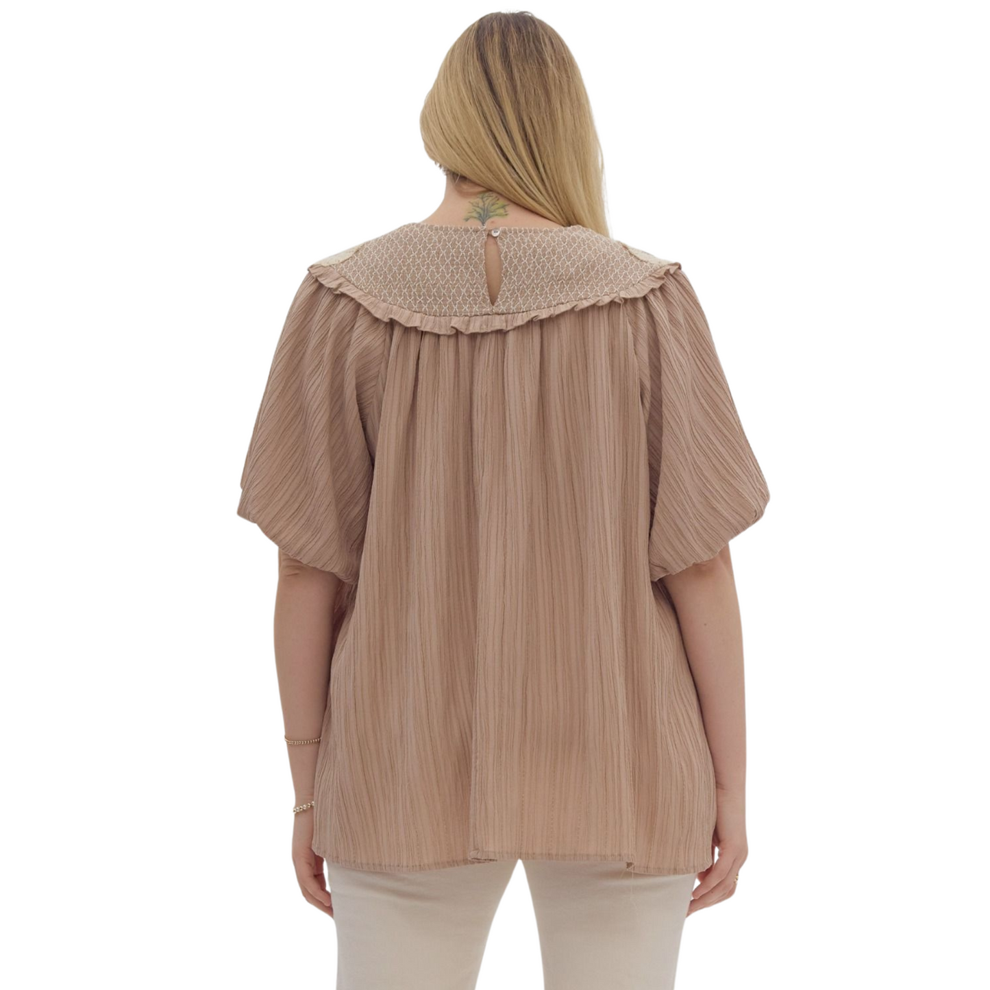 Upgrade your wardrobe with our Bubble Sleeve Embroidered Top. Made of lightweight woven fabric, it features a solid textured round neck with smocking and stitching detail, elastic cuffs, and a non-sheer finish. The gorgeous mocha color will add a touch of sophistication to any outfit. Perfect for both casual and formal occasions.