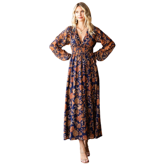 This elegant maxi dress is perfect for any special occasion. Crafted with a lined floral print fabric, a surplice neckline, elastic cuffed sheer long sleeves, and a smocked waistline, this item will add a hint of distinction and class to your wardrobe.