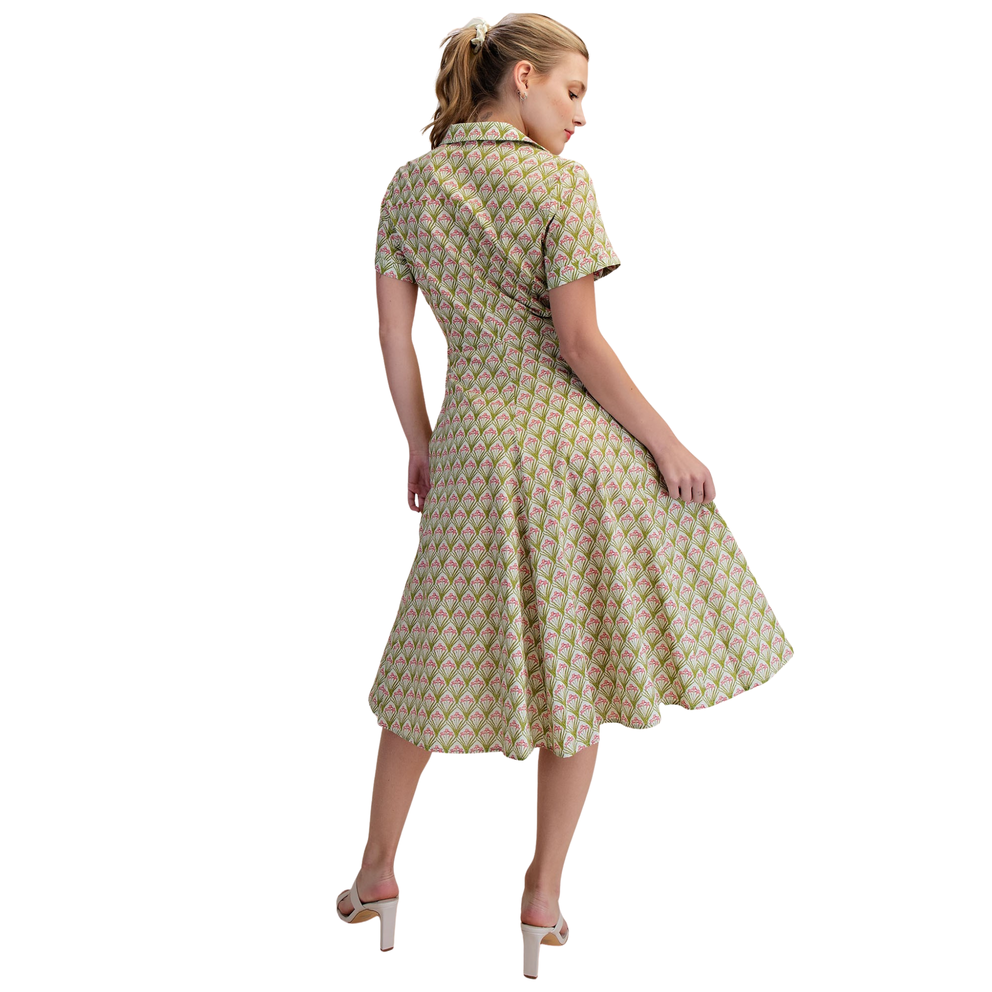 Elevate your everyday style with this charming Flower Print Shirt Dress from Glam. Featuring a vibrant floral print in rich green tones, this midi dress combines classic sophistication with modern flair. The collared neckline and short sleeves offer timeless appeal, while the front twist-tie detail adds a playful, flattering touch that cinches at the waist. Perfect for casual outings, brunch dates, or relaxed office settings, this versatile piece transitions seamlessly from day to night. The midi length pro