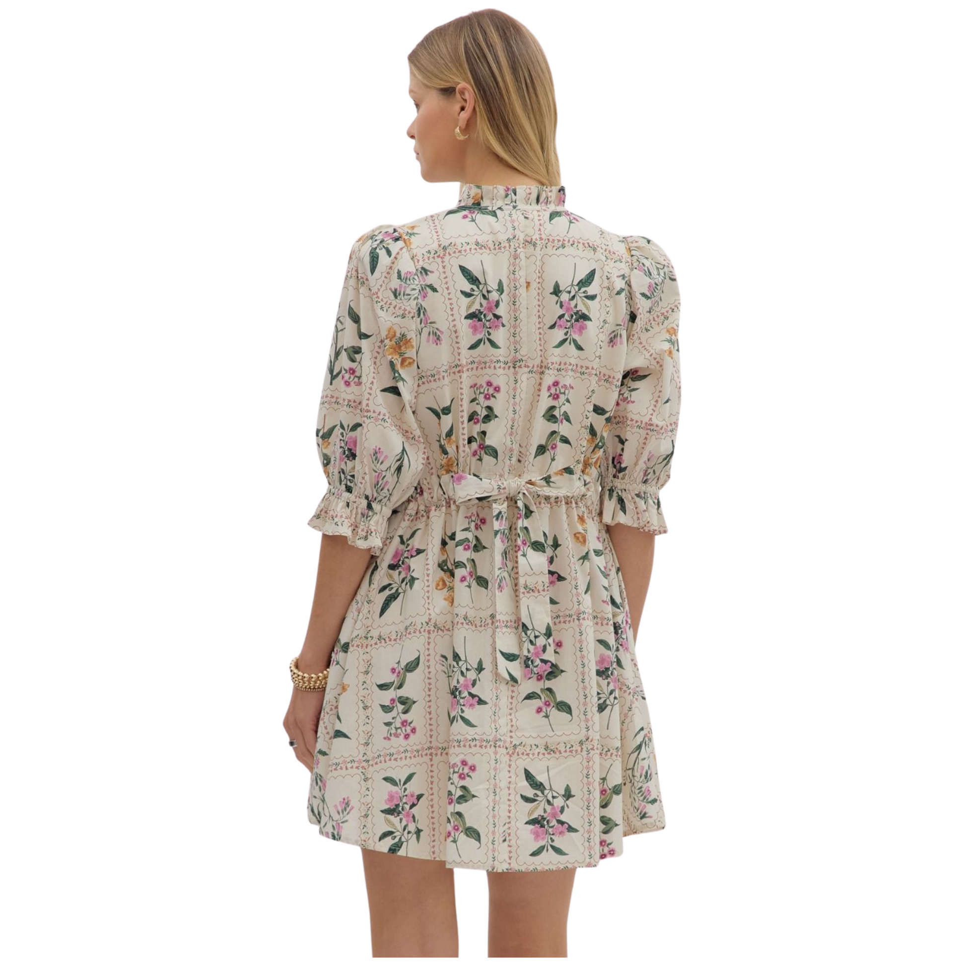 Floral panel ¾ ruffle finish puff sleeve pleated round neck button closure at front mini dress featuring adjustable back waist. Side pockets. Lined. Woven. Non-sheer. Lightweight.