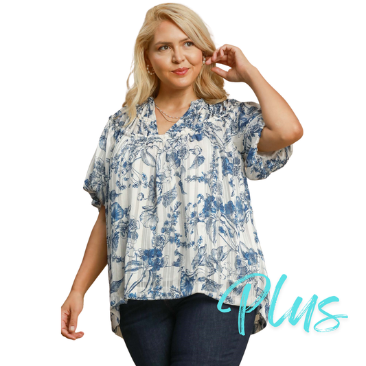 This Umgee brand Floral Split Neck Top features a beautiful blue floral print, perfect for adding a unique touch to your plus-size wardrobe. The short sleeves add a touch of comfort, making it an ideal choice for any occasion. Elevate your style with this stunning top.