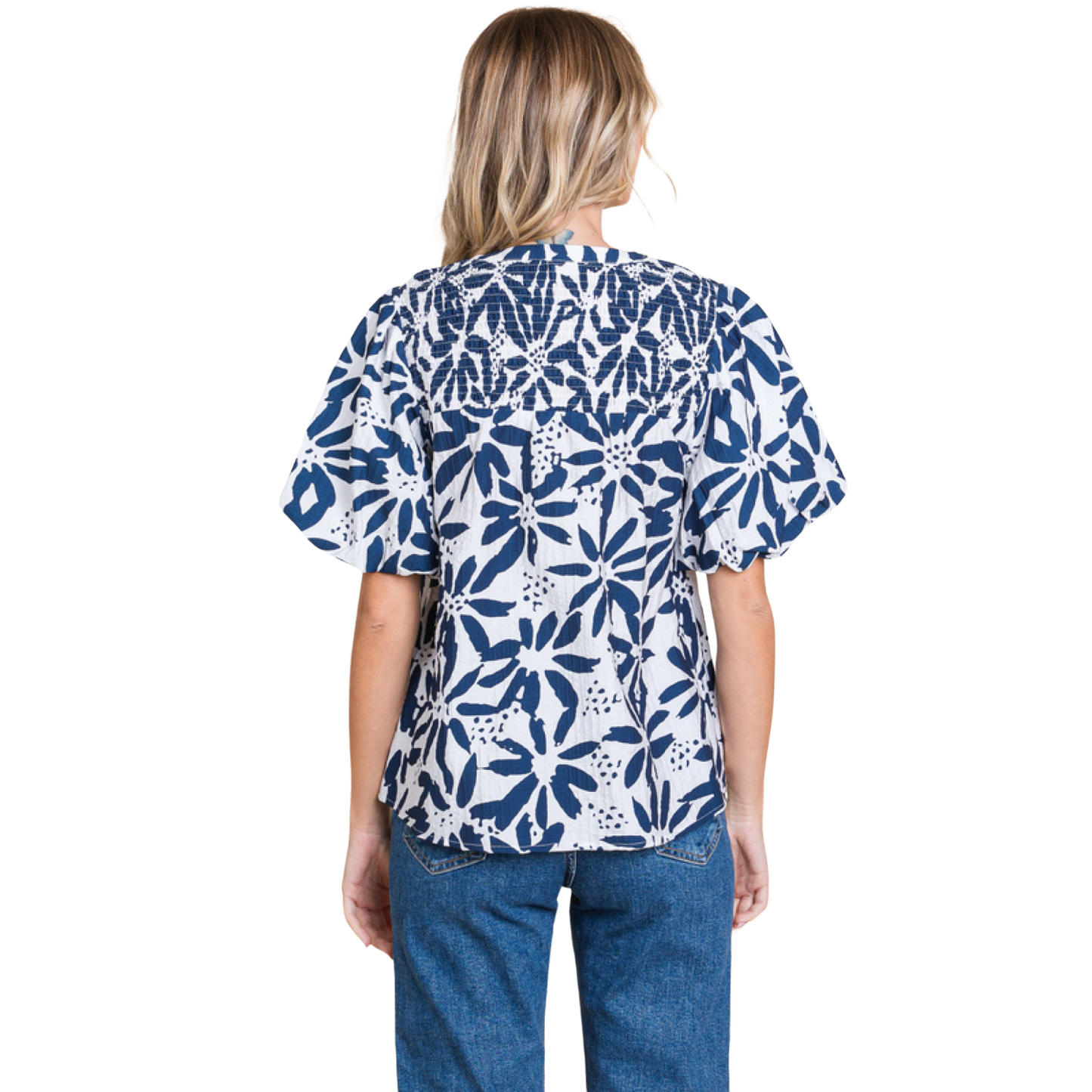 This Floral Smocked Tie Top features a charming flower print and a stylish self-tie neck. The smocked yoke adds a touch of texture, and the short puffed sleeves provide a feminine touch. Made of lightweight, non-sheer navy fabric, this top is perfect for any occasion.