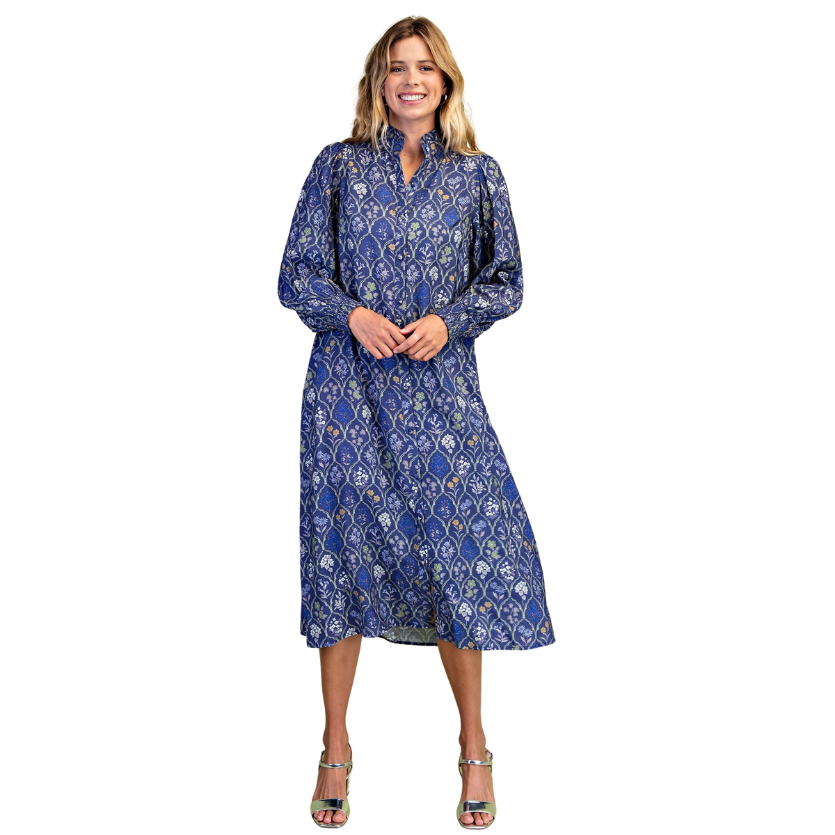 Discover effortless elegance with this stunning Floral Tile Midi Dress by GiGio. Rendered in a captivating blue base adorned with delicate floral tile print, this piece combines timeless charm with contemporary style. The ruffled collar adds a touch of feminine sophistication, while smocked long sleeves provide both comfort and visual interest. The button-down design allows for easy layering and styling versatility, making it perfect for transitions from day to evening. 