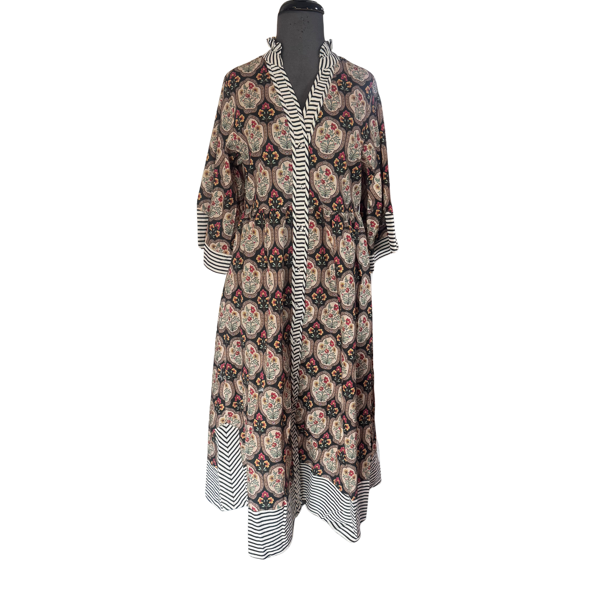 Elevate your everyday style with this elegant GiGio midi dress. Featuring a flattering v-neck and practical button-down front, it combines comfort with sophistication. The black and cream mixed floral tile print adds visual interest while remaining versatile enough to transition from day to night. Three-quarter length sleeves provide the perfect balance of coverage and breathability. A timeless piece that works beautifully for casual outings, work settings, or weekend gatherings.