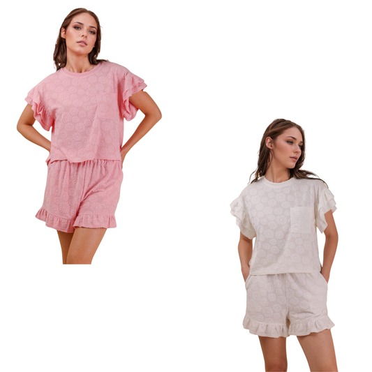 Elevate your casual wardrobe with this charming Textured Top and Shorts Set by Very J Brand. The knit floral top features delicate details that pair perfectly with ruffled shorts for a playful, put-together look. Available in soft pink or crisp white, this set offers versatile styling for warm-weather days. Mix and match with your favorite accessories for endless outfit possibilities.