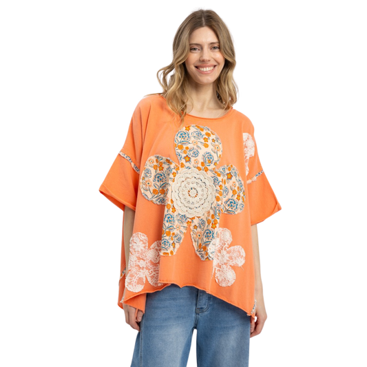 Embrace effortless style with this oversized floral patch top from Blue Velvet. Featuring a vibrant coral color and charming flower patch design, this relaxed-fit piece brings a playful, artistic touch to your everyday wardrobe. The generous silhouette offers comfort and movement, perfect for layering or wearing solo. A versatile staple that transitions seamlessly from casual outings to weekend gatherings.