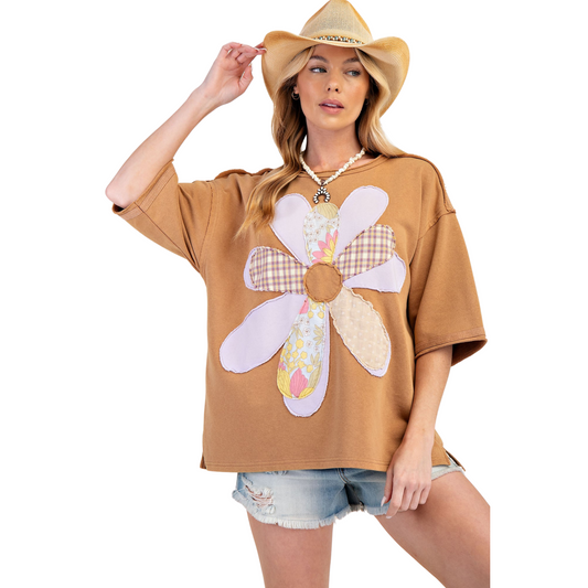 Introducing the Flower Patch Terry Knit Tunic Top, a stylish and comfortable addition to your wardrobe. This almond colored top features intricate flower patches and flattering half sleeves. From the trusted brand Easel, this tunic combines fashion and comfort for a must-have piece.