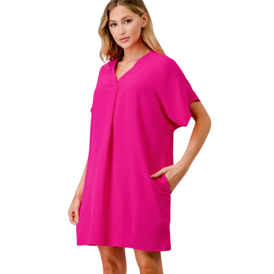 Made from soft and breathable fabric, the Aria Short Sleeve Shift Dress is the perfect addition to your wardrobe. The hot pink color adds a bold touch, while the v-neck and short sleeves provide style and comfort. This mini dress is a must-have for any fashion-forward individual.