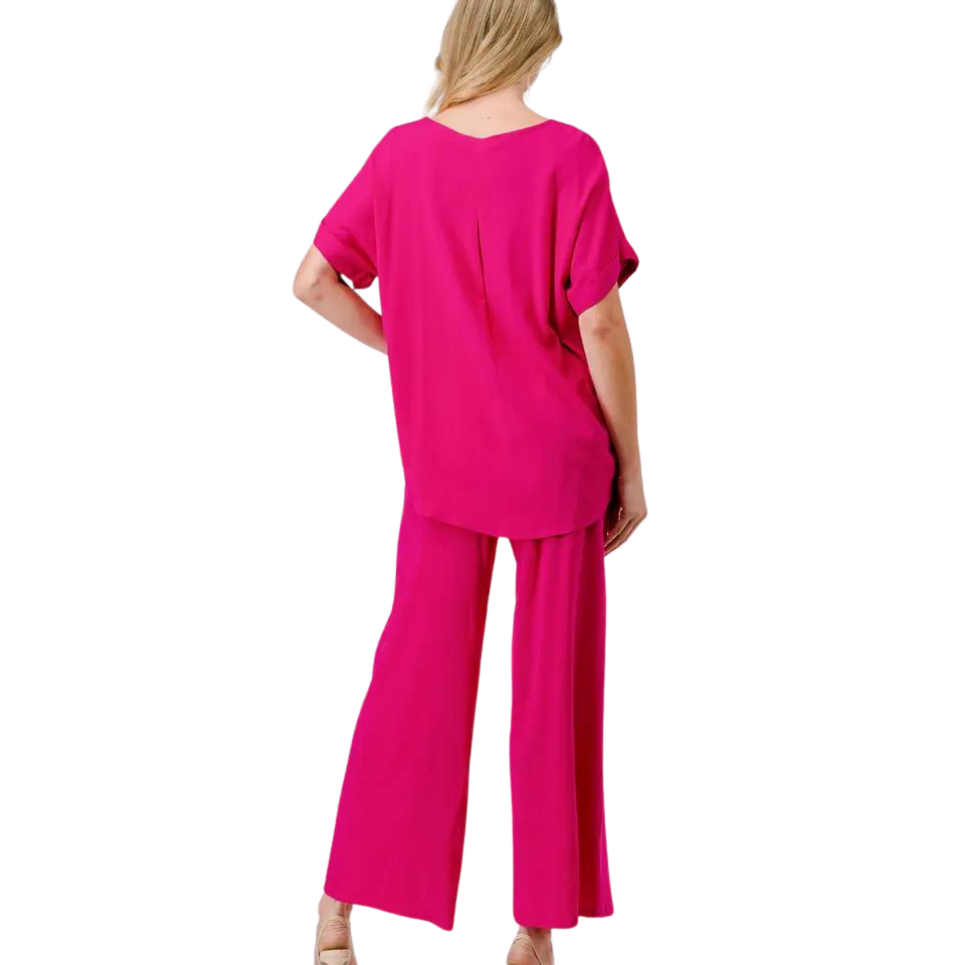 Crafted with a feminine fuchsia hue, this loose fit top and bottom set is the ultimate complete outfit. The short sleeve top and wide leg bottoms provide comfort and versatility, perfect for any occasion.