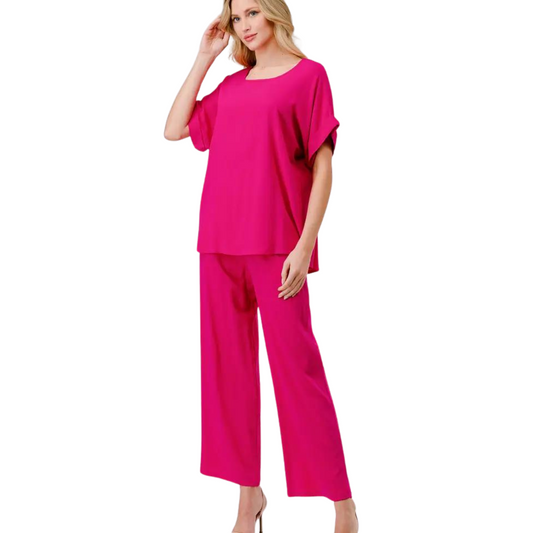 Crafted with a feminine fuchsia hue, this loose fit top and bottom set is the ultimate complete outfit. The short sleeve top and wide leg bottoms provide comfort and versatility, perfect for any occasion.