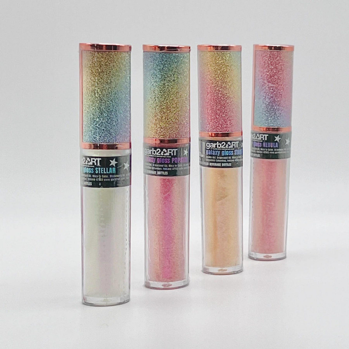 Galaxy Gloss is a top-quality lip gloss, handmade in the USA with natural ingredients. It provides extreme sparkle and nourishes your lips, giving them a fun, flavorful, and fabulous look. Available in various shades, including popstar, stellar, nebula, and starstruck. Experience the out-of-this-world shine with Galaxy Gloss.