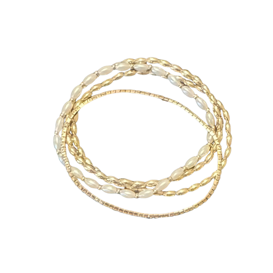 Master the art of stacking with ETE brand's layered stretchy bracelets, featuring elegant gold and pearl detailing. These expertly designed pieces combine timeless materials with practical comfort—the stretchy construction adapts to any wrist size without compromising sophistication. Layer multiple bracelets to create a curated, high-impact aesthetic, or wear individually for refined simplicity. The lustrous pearls and warm gold tones work harmoniously across various skin tones and occasions. 