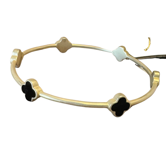 This elegant gold bangle features a black cross accent, making it the perfect accessory for any occasion. Crafted with gold and delicately detailed, it is sure to add subtle style to any ensemble.