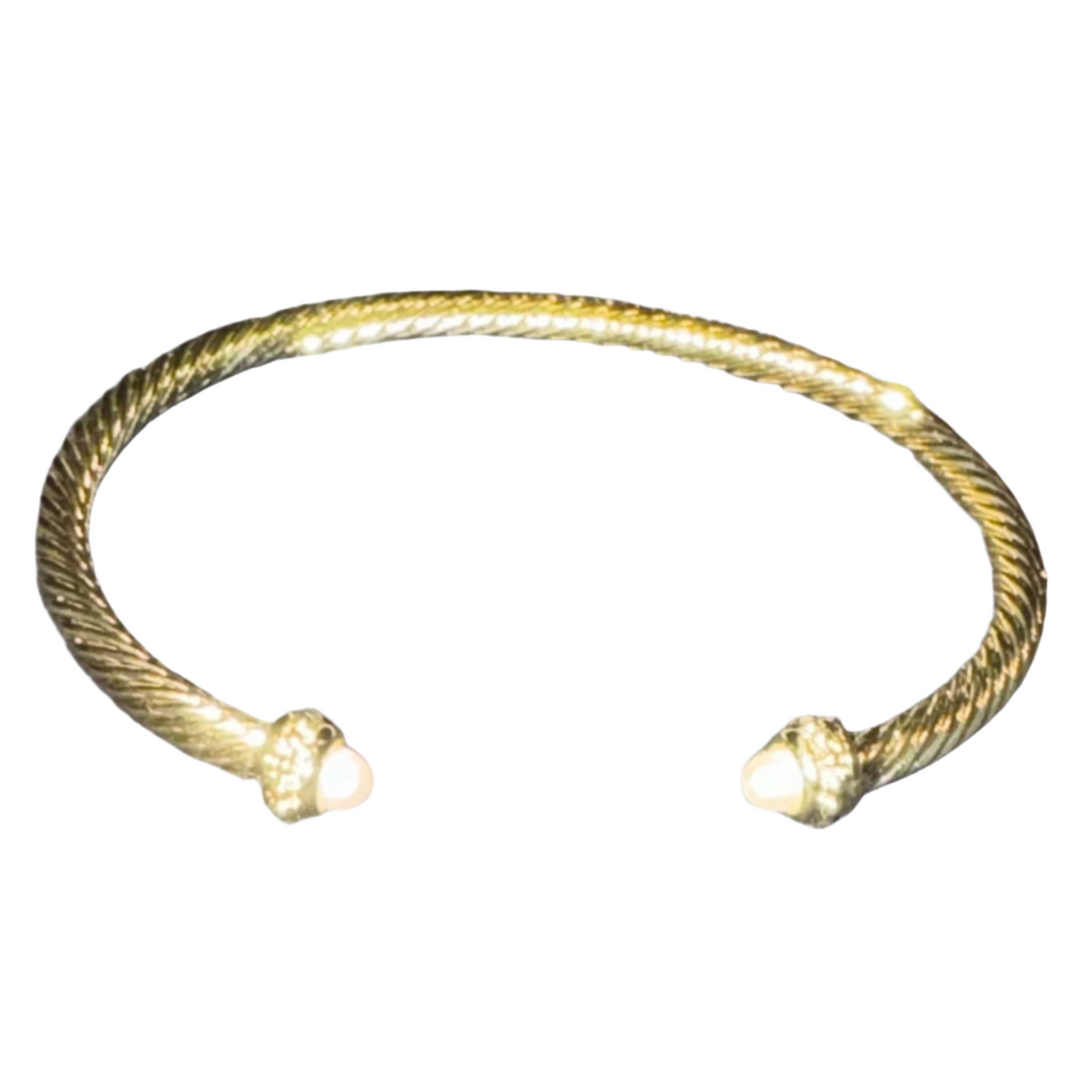 This gold cuff bangle features a classic cuff style with a bangle bracelet design. It is accented with a beautiful pearl and strategically placed rhinestones for an elegant look. Crafted with quality materials, it adds a touch of sophistication to any outfit.