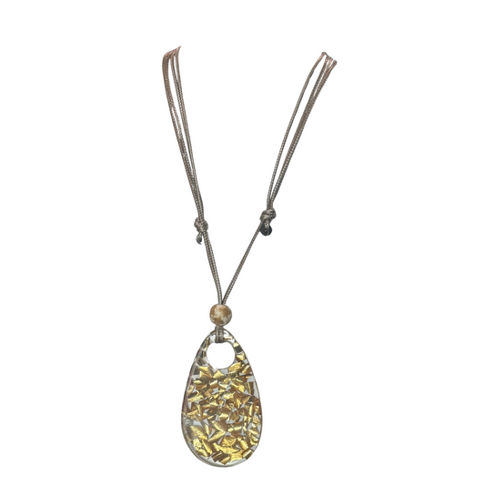 Elevate your style with the Gold Flake Apoxy Pendant Necklace from Golden Stella. This expert-crafted piece features delicate gold flakes suspended in clear epoxy, creating a unique shimmer that catches the light beautifully. The adjustable necklace ensures a perfect fit for any neckline, combining versatility with refined elegance. Ideal for adding a subtle yet sophisticated accent to both casual and formal outfits.