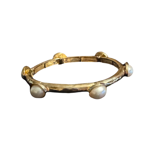 This elegant Stretchy Pearl Bangle adds a touch of sophistication to any outfit. Made with high-quality gold and adorned with delicate pearl accents, this bangle style bracelet effortlessly stretches for a comfortable fit. Elevate your style with this versatile and timeless accessory.