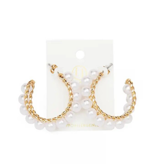 Elevate your style with our Gold and Pearl Hoops. These expertly woven hoops are lined with lustrous pearls, adding a touch of elegance to any look. Made with high-quality gold, these hoops are both timeless and durable. A must-have for any fashion-forward individual.