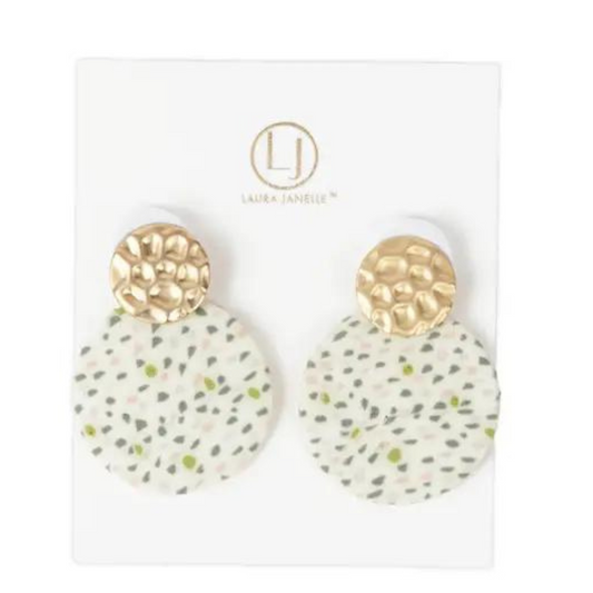 These Speckle Clay Circle Earrings are expertly designed with a speckle pattern that adds a unique touch to any outfit. The stunning gold accent elevates the overall look of these dangle earrings, making them a must-have for any fashion-forward individual. Enjoy the perfect balance of style and sophistication with these earrings.