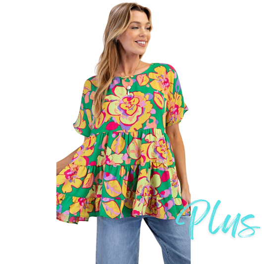 This Floral Print Babydoll Tunic features a rounded neckline and a back button closure for easy wear. Designed with short sleeves and a tiered, ruched bottom, it offers a loose, relaxed fit that enhances comfort. Its flowy silhouette makes it an ideal choice for effortless style and breathability in warmer weather. Perfect for layering or wearing on its own, this tunic combines feminine details with practical design.