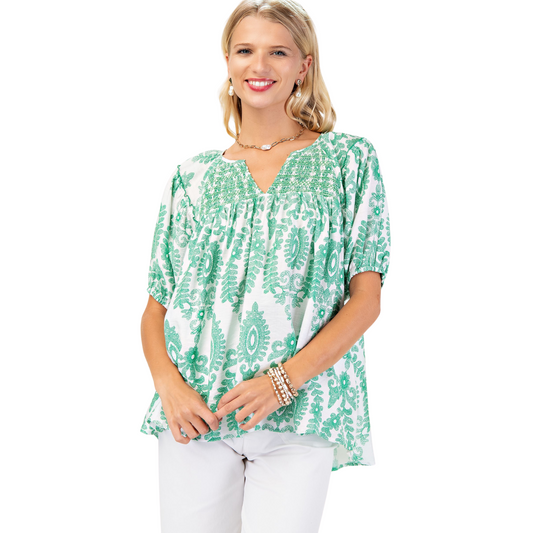 This GiGio short sleeve top features a vibrant green color with an abstract design, combining style and comfort. Crafted for a perfect fit, it offers breathability and ease of movement, making it ideal for both casual and professional settings. Its modern aesthetic reflects expert tailoring and attention to detail.