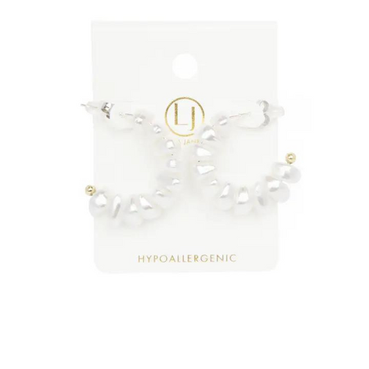 These professionally crafted half moon hoops are lined with delicate pearls, adding a touch of elegance to any outfit. Made of high-quality gold, these hoops are a must-have for any fashion-forward individual. Upgrade your style with these timeless and sophisticated Pearl Lined Hoops.