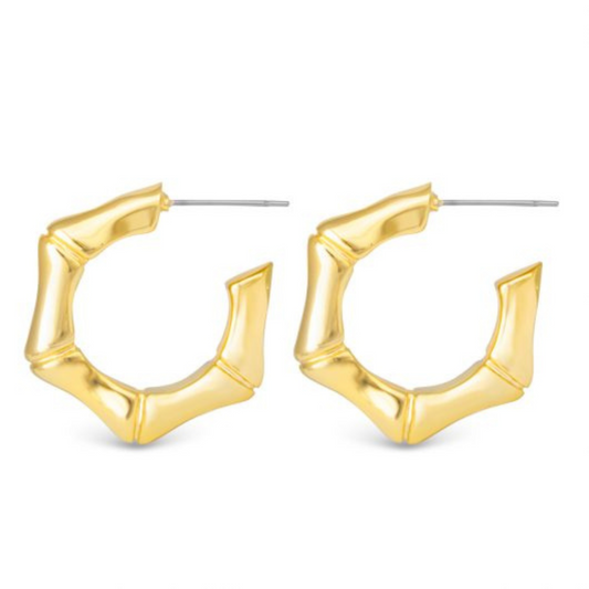 Expertly crafted by Amanda Blu, these Jenna Polished Bamboo Hoops feature a timeless bamboo design in shiny gold. Elevate any outfit with these classic hoop earrings, sure to add a touch of sophistication and style to your look.