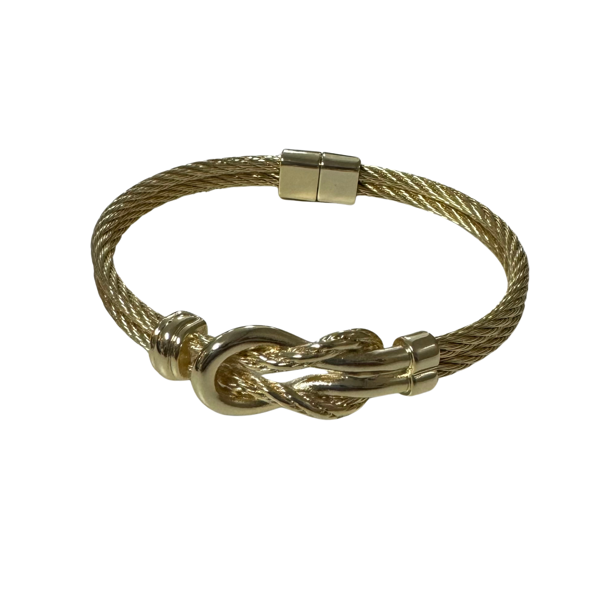 Expertly crafted with a golden knotted design, this cuff bangle exudes elegance and sophistication. Its magnetic closure ensures a secure fit while adding a touch of modernity to this timeless piece. Elevate any outfit with this versatile and stylish accessory.