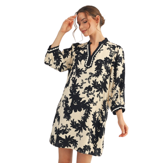 This black mini dress from Jodifl features a delicate floral print and elegant lace trim that enhances its refined style. The 3/4 length sleeves offer a balanced coverage, making it perfect for both day and evening occasions. Its shift silhouette provides a comfortable yet flattering fit, combining classic design with subtle detailing for a versatile wardrobe staple.