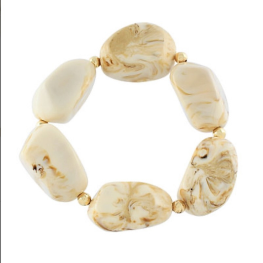 Elevate your everyday style with this Large Beaded Stretchy Bracelet from Golden Stella. Crafted with beautiful beige beads, this versatile piece stretches to fit most wrist sizes comfortably. The timeless neutral tone pairs effortlessly with any outfit, making it perfect for layering or wearing solo. Durable and lightweight, it's an essential accessory for both casual and dressed-up occasions.