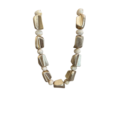 Elevate your everyday style with this stunning beaded necklace from Perdido Gems. Crafted in a sophisticated gold and beige color combination, this short necklace features carefully selected beads that create a refined, versatile look. Perfect for layering or wearing solo, it adds a touch of elegance to any outfit. The compact length makes it ideal for both casual and dressed-up occasions, while the quality craftsmanship ensures lasting wear.