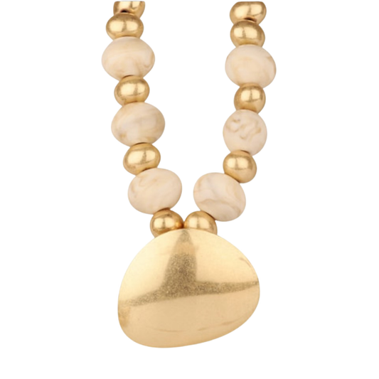 Elevate your everyday style with this striking short beaded necklace from Golden Stella. Featuring large, lustrous beads paired with a bold gold pendant, this piece makes an instant statement. The shorter length sits perfectly at the collarbone, ideal for layering or wearing solo. Crafted for those who appreciate quality jewelry that combines elegance with contemporary flair.