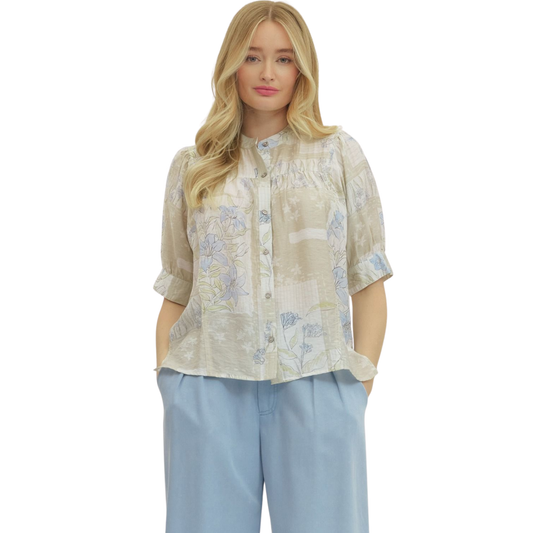 Elevate your everyday wardrobe with this charming Botanical Print Short Sleeve Top by Entro. Featuring a soft latte base adorned with delicate floral patterns, this collared button-down top combines timeless style with modern comfort. The classic silhouette and quality construction make it perfect for casual outings, office settings, or weekend gatherings. Versatile and effortlessly chic, this piece pairs beautifully with jeans, skirts, or trousers for endless styling possibilities.