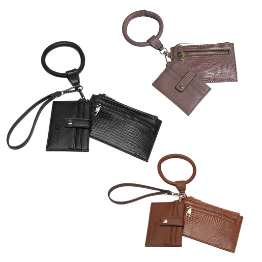 The Libby Lizard Wallet Bangle by Jen &amp; Co. combines style and functionality in a unique accessory. Available in black, brown, and mauve, this bag-in-a-bag design offers a compact solution for carrying essentials. Its bangle form ensures easy wear and quick access, making it ideal for those who value convenience without sacrificing elegance. Perfect for organizing cards, cash, and small items securely while complementing your outfit with a sophisticated touch.