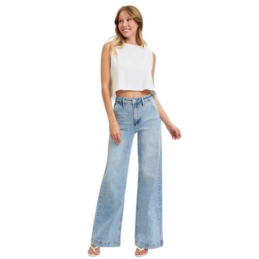 These High Rise Wide Leg Jeans by Risen offer a modern silhouette with a relaxed yet flattering fit. Crafted in a light wash, they feature wide legs that provide comfort and movement. Slanted pockets add a functional detail while enhancing the streamlined look. Ideal for stylish everyday wear, these jeans balance classic denim appeal with contemporary design.
