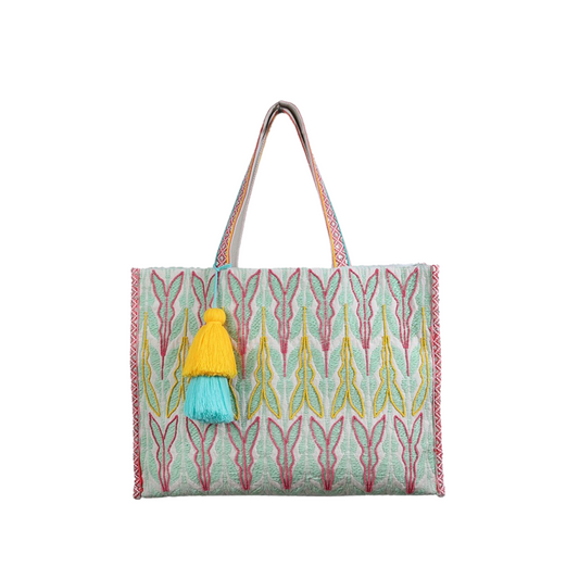 The Locke Cotton Tote features a woven pattern and decorative detailing in a stylish sage and pink color scheme. With a convenient snap closure and large tassel, this tote is perfect for both everyday use and special occasions. Made with durable cotton for a high-quality and chic design.