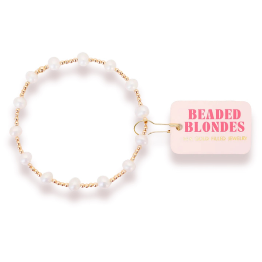 Elevate your everyday style with the Lolo Pearl Beaded Bracelet from Beaded Blondes. This stretchy bracelet features lustrous pearl beads paired with gleaming gold accents, creating a timeless yet modern aesthetic. The comfortable stretch fit ensures all-day wearability, while the elegant bead combination makes it perfect for layering or wearing solo. A versatile accessory that transitions seamlessly from casual to sophisticated occasions.