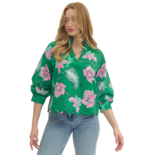 Elevate your wardrobe with this stunning Long Sleeve Floral Top by Entro. Featuring a vibrant green floral print, this piece combines timeless elegance with modern style. The flattering v-neck neckline and long sleeves provide comfortable coverage, while the delicate scalloped hem adds a feminine touch. Perfect for layering or wearing solo, this versatile top transitions seamlessly from casual days to evening outings. A must-have addition to any fashion-forward closet.