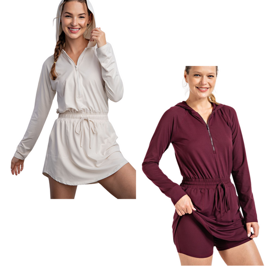 The 2 in 1 Active Romper by Rae Mode Brand provides butter soft comfort and versatility. Available in both burgundy and white pearl, this romper features long sleeves, a cozy hoodie, convenient pockets, and a zipper front for easy wear. Perfect for any occasion.