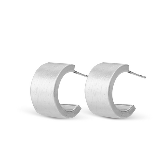 These Amy Flat Huggie Hoops are made from high-quality silver and feature a sleek matte finish. Their small hoop design adds a touch of sophistication to any outfit. These hoop earrings are a must-have for any modern wardrobe.