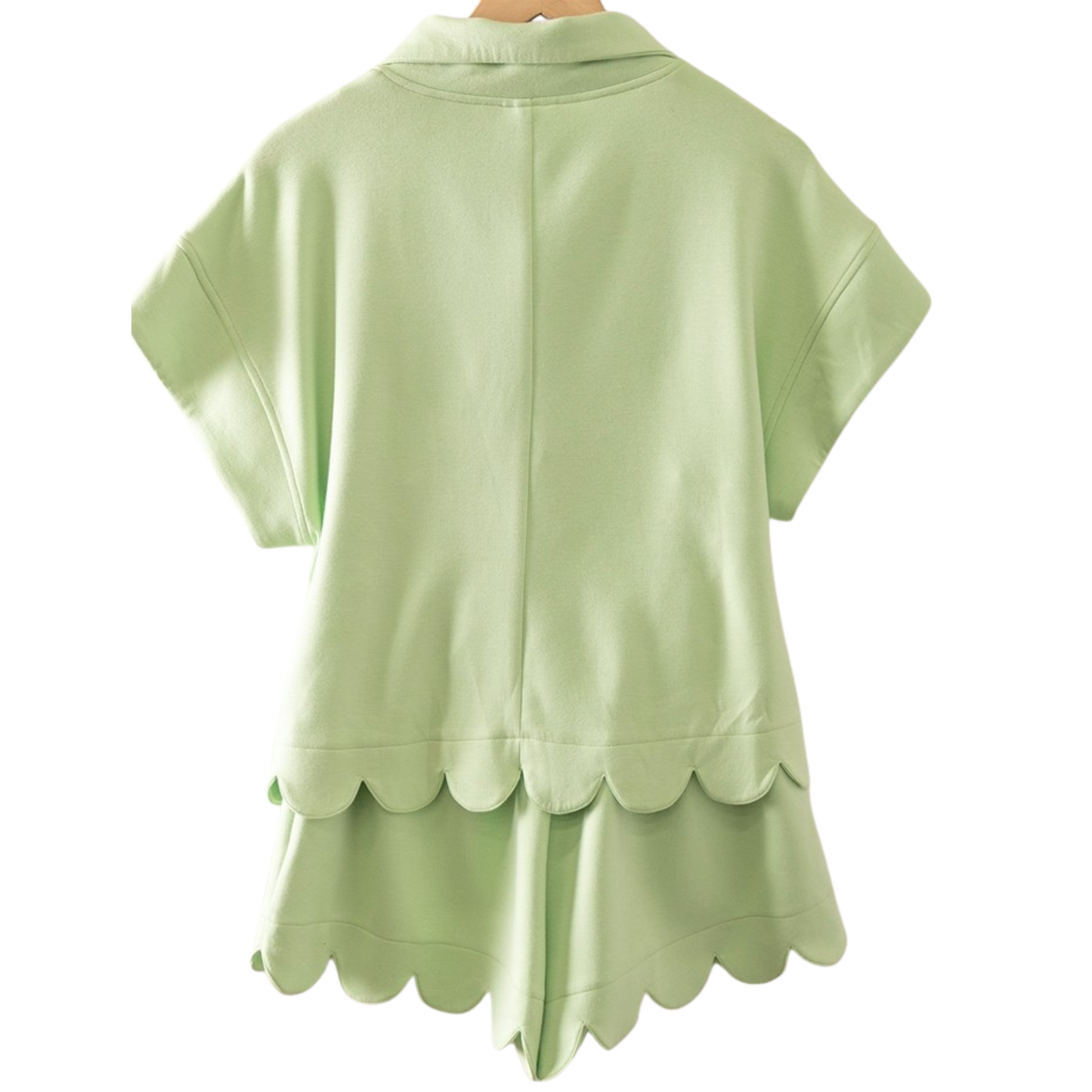 Elevate your casual wardrobe with this charming melon green set from Very J. The short-sleeve half zip top pairs perfectly with matching shorts featuring a delicate scalloped hem for a playful, feminine touch. Lightweight and comfortable, this coordinated duo is ideal for warm weather outings, weekend relaxation, or effortless layering. The soft color and thoughtful details make it a versatile staple that transitions seamlessly from day to night.