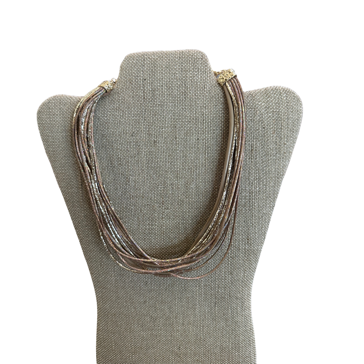 Elevate your everyday style with this stunning layered necklace from Perdido Gems. Crafted in a sophisticated blend of taupe and gold metallics, this short necklace features delicate layered strands that create dimension and visual interest. Perfect for adding a touch of elegance to any outfit, whether dressed up or down. The metallic finish catches the light beautifully, making it a versatile piece that complements both warm and cool-toned wardrobes.