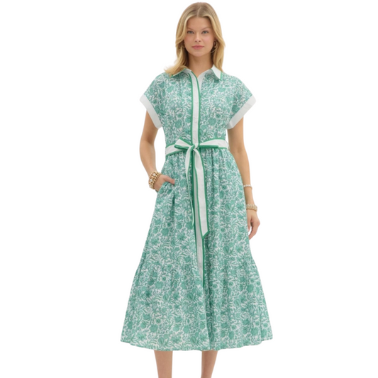 This floral midi shirtdress by Entro is both classy and sophisticated. Featuring a collared neckline, a green and white floral print, short sleeves, and a tie waist, this dress is perfect for any occasion. Stay stylish and comfortable with this versatile piece.